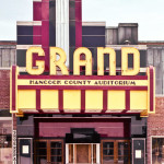 Grand Theater - Maine. The burgundy color appears to be PPG Carrara glass.